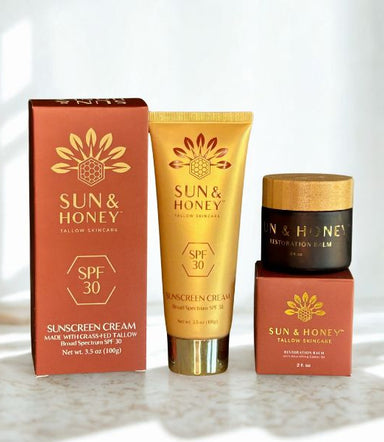 Sun and Honey skincare products including a tallow sunscreen, tallow face cream, and tallow balm on a light background.