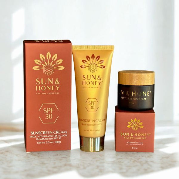 Sun and Honey skincare products including a tallow sunscreen, tallow face cream, and tallow balm on a light background.
