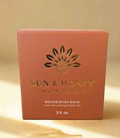 Sun & Honey tallow skincare restoration balm packaging on a beige background